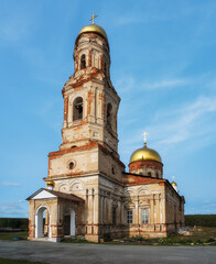 Ancient bell tower of the Church of Michael the Archangel in the village of Maminskoye (Ural, Russia) in summer.