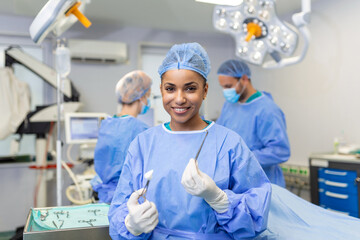 Portrait of African American woman surgeon standing in operating room, ready to work on a patient....