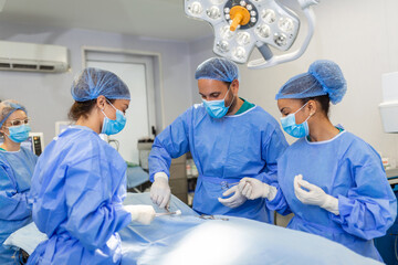 Shot of a team of surgeons performing a surgery in an operating theatre