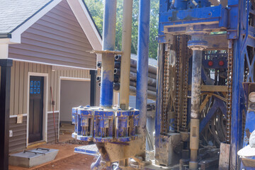 Portable hydraulic well drilling rig located on water extraction a land plot owned by the owner