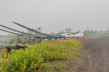 Giant blades used on wind turbines laying in vacant field awaiting installation.