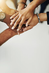 Hands in a huddle for teamwork, unity and working together from above. Closeup of a diverse group...