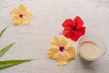 cup coffee and hibiscus at the beach.