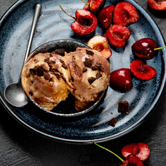 Chocolate ice cream with berries on dark background