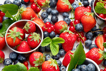 Various fresh berries on neutral background.