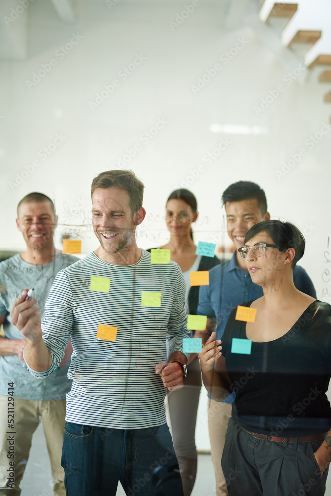 Poster Confident manager, leader or boss talking in a meeting, workshop or presentation with sticky notes in the boardroom. Businessman talking, discussing and brainstorming with a group of colleagues