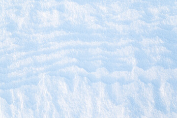 Close-up of fresh snowy land in the winter on a sunny day, viewed from above. Abstract full frame textured background. Copy space. Top view.