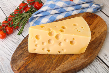 Maasdam cheese piece over board