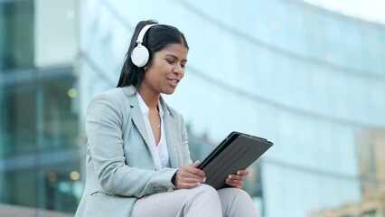 Business woman talking on video conference, video call or meeting while sitting in the urban city alone. One Indian entrepreneur, freelancer and professional making conversation and discussing