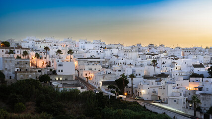 Beautiful Andalusian Pueblo Blanco (white village) at sunset. Vejer de la Frontera is one of the most beautiful Pueblos Blancos in Cádiz province, Andalusia, Spain. - obrazy, fototapety, plakaty