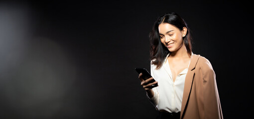 Half body portrait of Asian beautiful woman wear white shirt, using internet smart phone