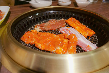 Korean raw pork grill on the grill with flames.