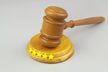 Attorney rating concept. Judge gavel with five stars on gray background. Copy space for text.