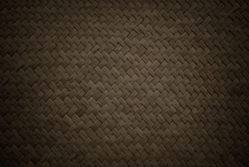 Old dark brown reed weaving mat texture background, pattern of woven rattan mat in vintage style.