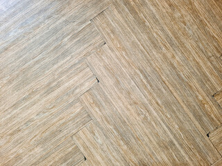 The brown wooden floor has jagged edges.