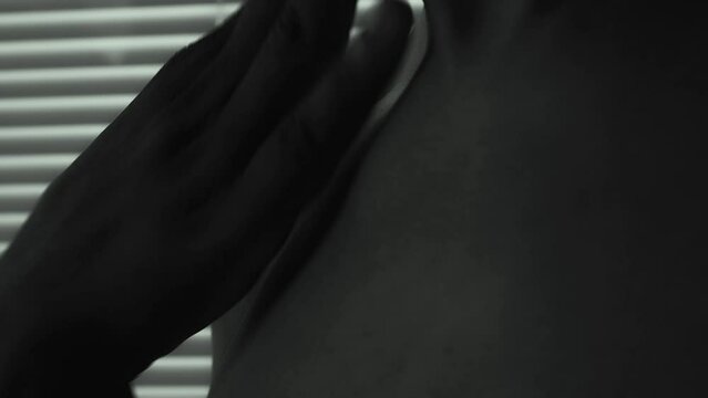 Afro African Black Man cleaning is screechy skin.