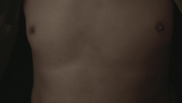 Afro man showing of his body and chest