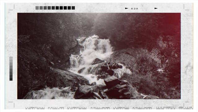 Retro photo camera screen with waterfall scene in mountains, national park of Dombay, Caucasus, Russia. Summer landscape with sunshine weather