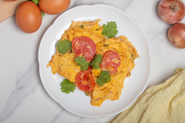 Oil-free tomato omelette in a white plate. Healthy food ideas for weight loss.
