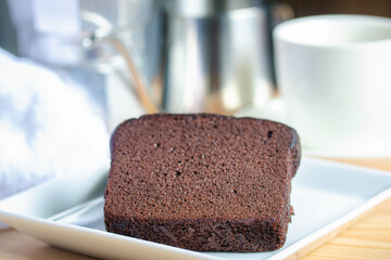 Chocolate cake with coffee in a white plate