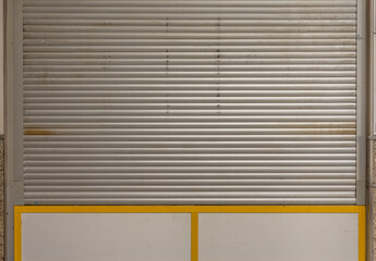 a closed shop window with roller shutter