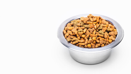 A metal bowl with dry food for animals, cats and dogs, isolated on a white background
