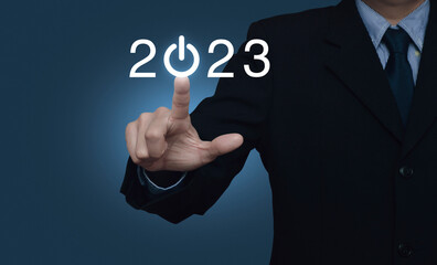 Businessman pressing 2023 start up business flat icon over light blue background, Business happy new year 2023 cover concept