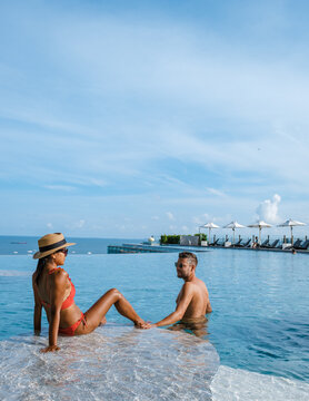 couple man and woman on a luxury vacation enjoying the infinity pool on the rooftop, Pattaya Thailand. sunny day in Pattaya