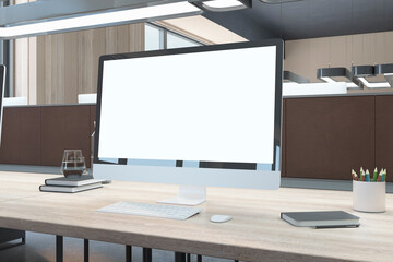 Close up of creative wooden designer desktop with blank white mock up computer monitor and supplies in modern coworking office with partition. 3D Rendering.
