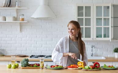 Beautiful woman in the kitchen while preparing a vegetarian breakfast. Healthy eating.