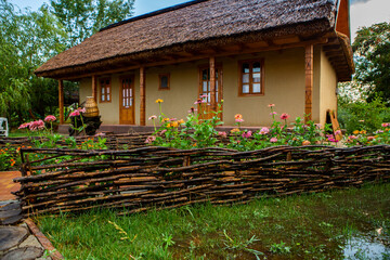 Fototapeta na wymiar Rural house made of clay and clay roof. The ideal country house for rest and relaxation in the bosom of nature