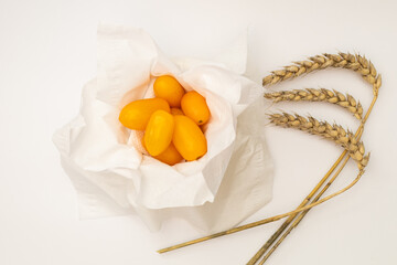 Yellow cherry tomatoes on a white background