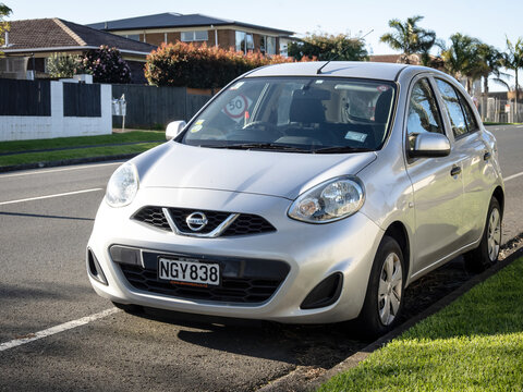 Silver Nissan Micra, generation IV (K13) facelift 2013-2016. Front left view. Stock photo. Auckland, New Zealand