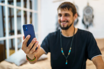Young man using mobile phone for video call