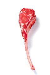 Fresh uncooked tomahawk steak on the bone on white background. Prime cut of beef. High quality...