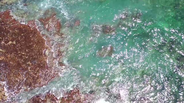 Aerial view of clear turquoise sea and waves