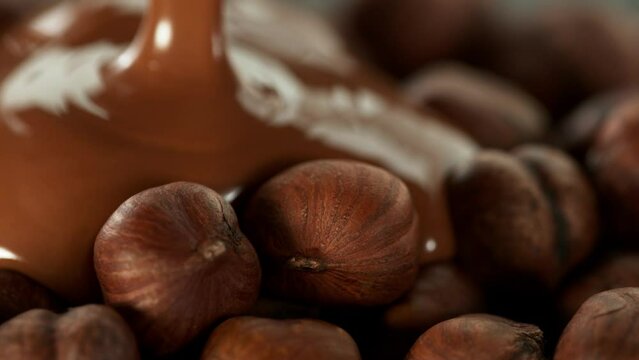 Super Slow Motion of Pouring Melted Chocolate on Hazelnuts. Filmed on High Speed Cinema Camera, 1000fps.