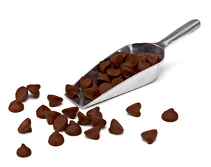 Chocolate chips or chocolate parts in  scoop from top view on white background	
