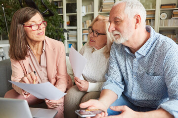 Finanzberaterin zeigt Senioren Paar ein Formular