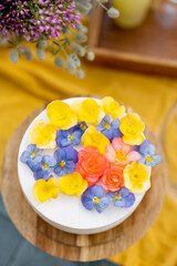 Obraz na płótnie Canvas Cheesecake decorated with edible flowers on garden table