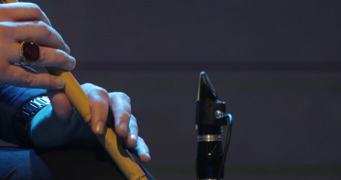 A slightly moving shot of a musician playing on his ney - the Sufi music instrument