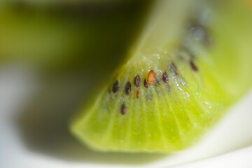 Close-up of a cut segment of a fresh kiwi fruit