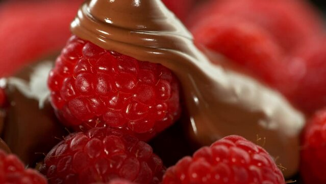 Super Slow Motion of Pouring Raspberries with Melted Chocolate. Filmed on High Speed Cinema Camera, 1000fps.