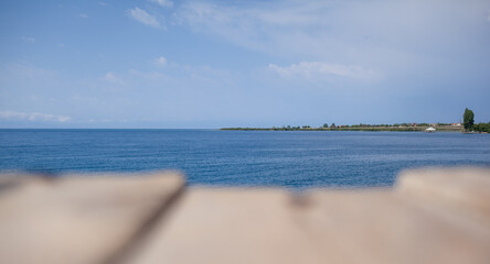 Wooden planks on the pier above the blue sea. Wooden planks on top of the water.