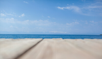 Wooden planks on the pier above the blue sea. Wooden planks on top of the water.