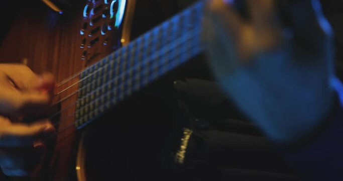 Footage of a musician playing his guitar