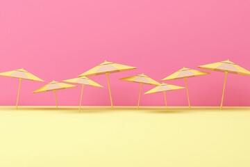 Many yellow umbrella floating on pastel pink background , 3d rendering. 3d illustration. Summer and travel minimal concept.
