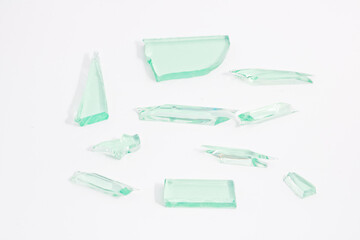 Abstract broken green glass in motion into pieces isolated on white background.