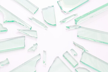 Abstract broken green glass in motion into pieces isolated on white background.