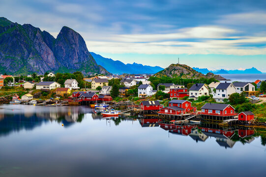 Reine Village With Red Rorbu Cottages And Mountains On Lofoten Islands, Norway